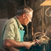 senior-male-turner-working-on-lathe-machine-in-workshop-3811859